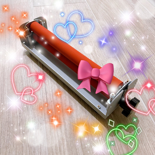 Angled top view of a compact cold laminator machine for A4 paper with orange rollers, decorated with pictures of hearts and bows. This machine is used for applying cold laminate sheets to sticker paper.