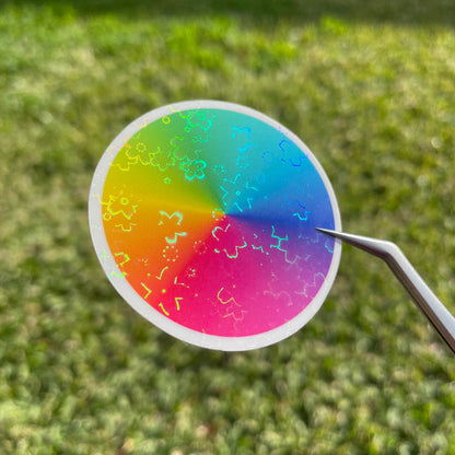 Top view of a colour wheel sticker in natural sunlight, showing the cluster of flowers that make up the A4 flower holo glossy cold laminate sheets.