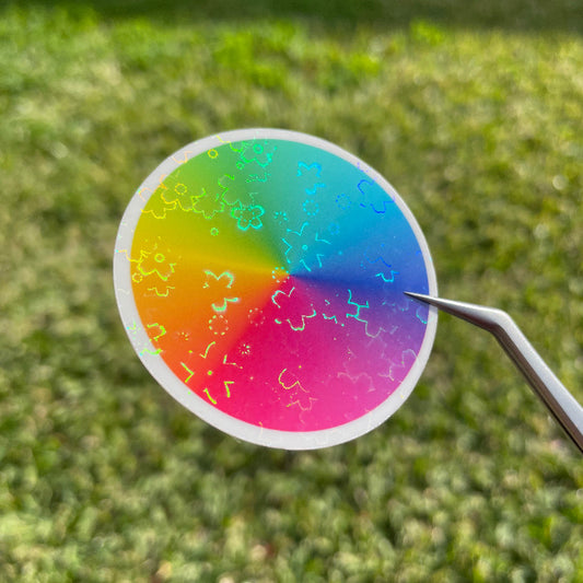 Top view of a colour wheel sticker in natural sunlight, showing the cluster of flowers that make up the A4 flower holo glossy cold laminate sheets.